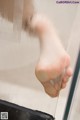 A close up of a person's foot in a shower.